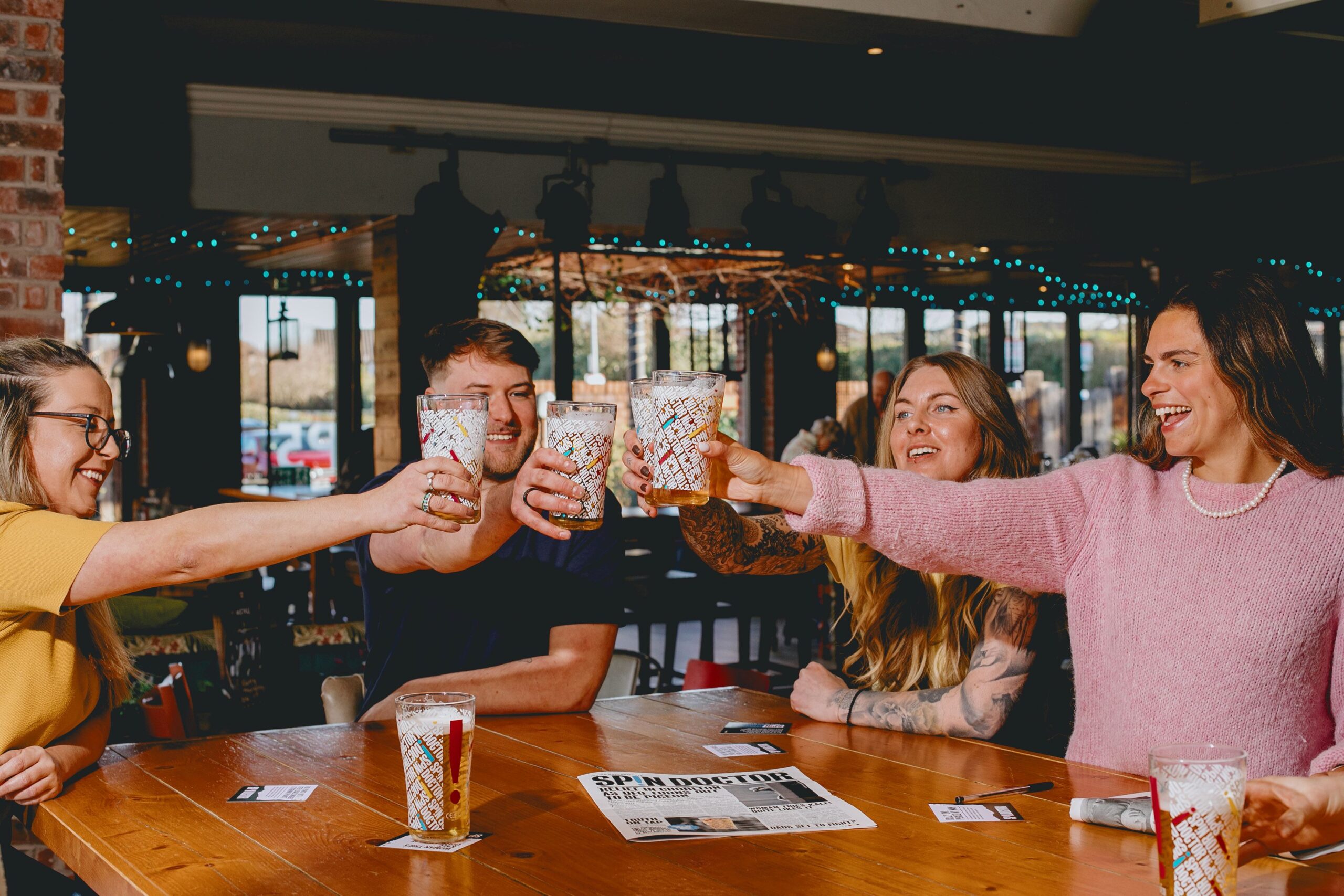 Group of friends cheering drinking beer