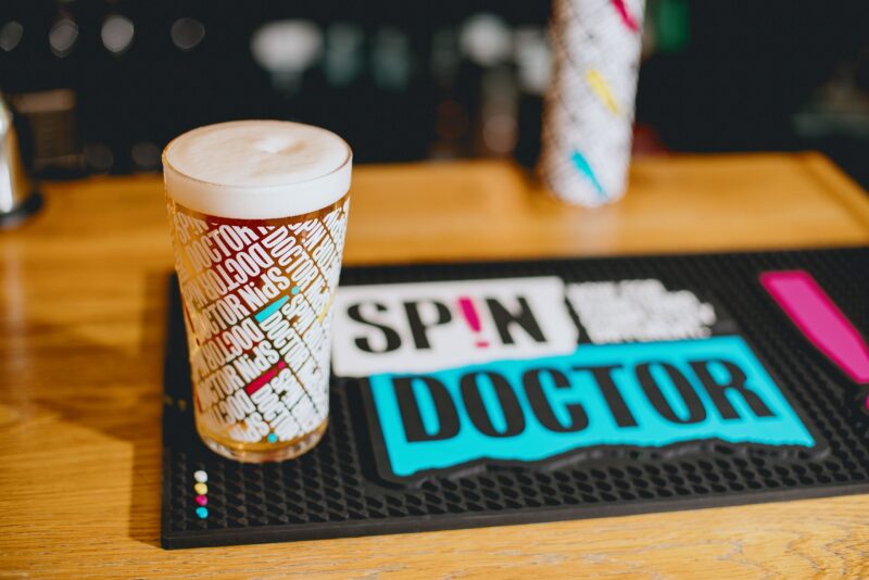 Pint of Spin Doctor beer on a bar runner