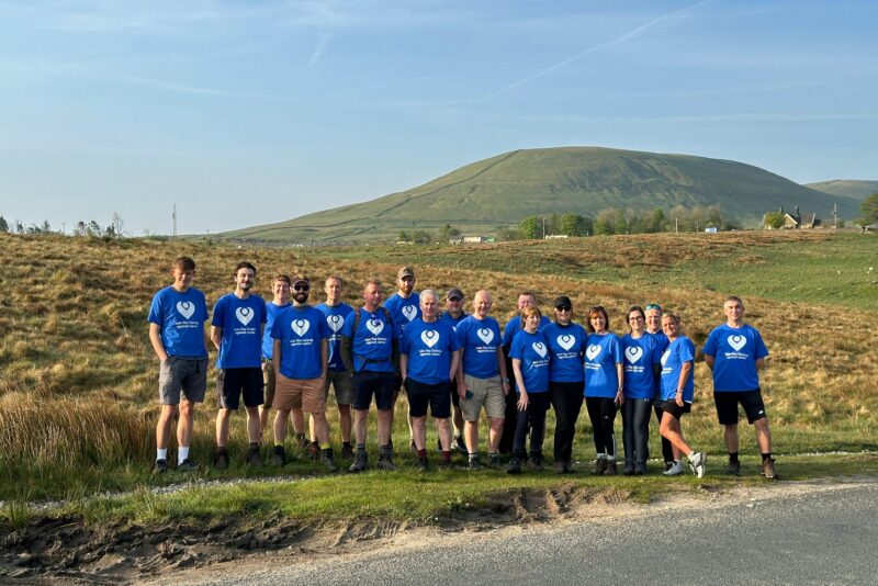 A group of people stood in the countryside.