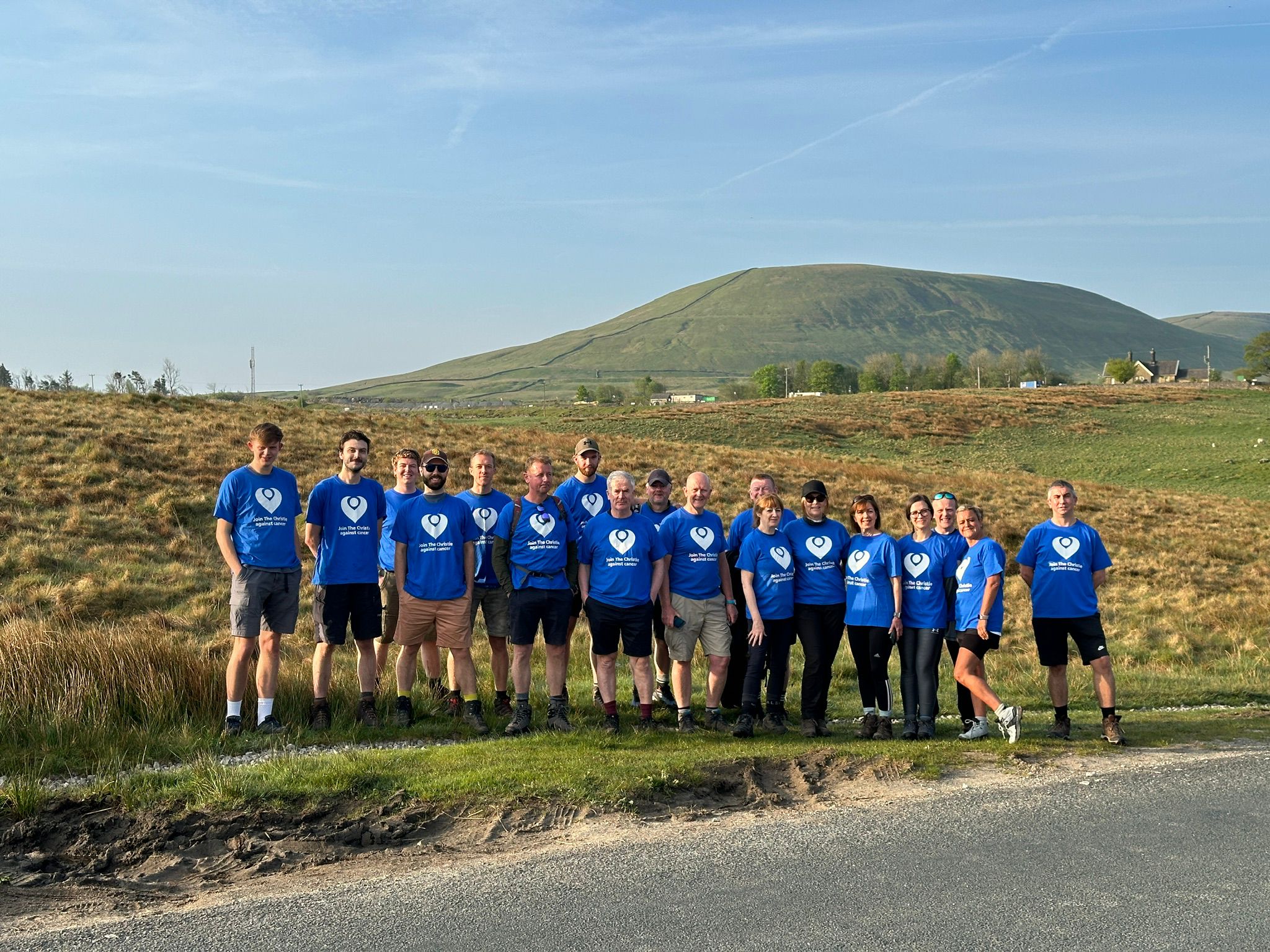 A group of people stood in the countryside.